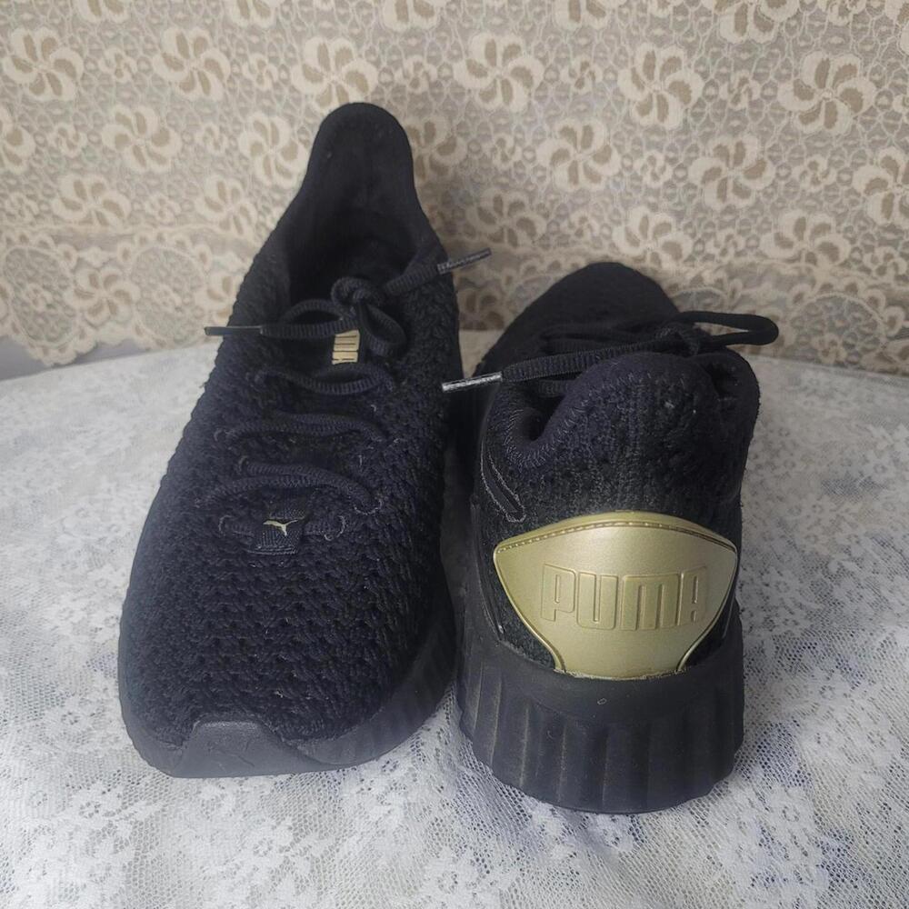 Women's PUMA Defy Luxe Black and Gold sneakers